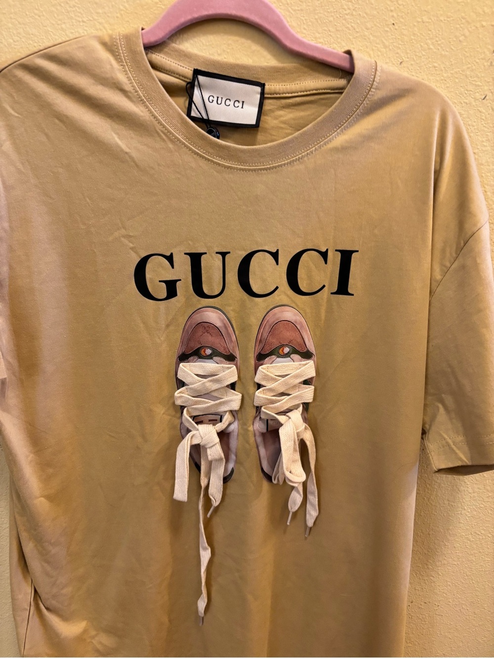 Gucci Beige Tee with Sneaker Graphic and Black Logo